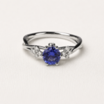 Anello Adamas con zaffiro blu centrale a sei griffe — dettaglio incastonatura